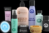 Assorted skincare product containers with various designs, featuring the brand name Orchid Lifesciences on some items.